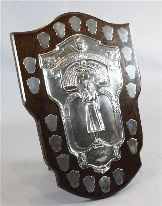 A large George V 1930s silver mounted oak presentation shield,The Ada Florence Cuthbert Memorial Shield,